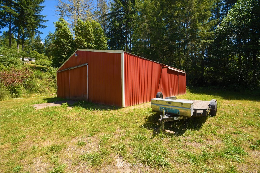 267 East Victor Road Belfair, WA 98528 - Photo 23 of 27 a backyard of a house with yard fountain and outdoor seating