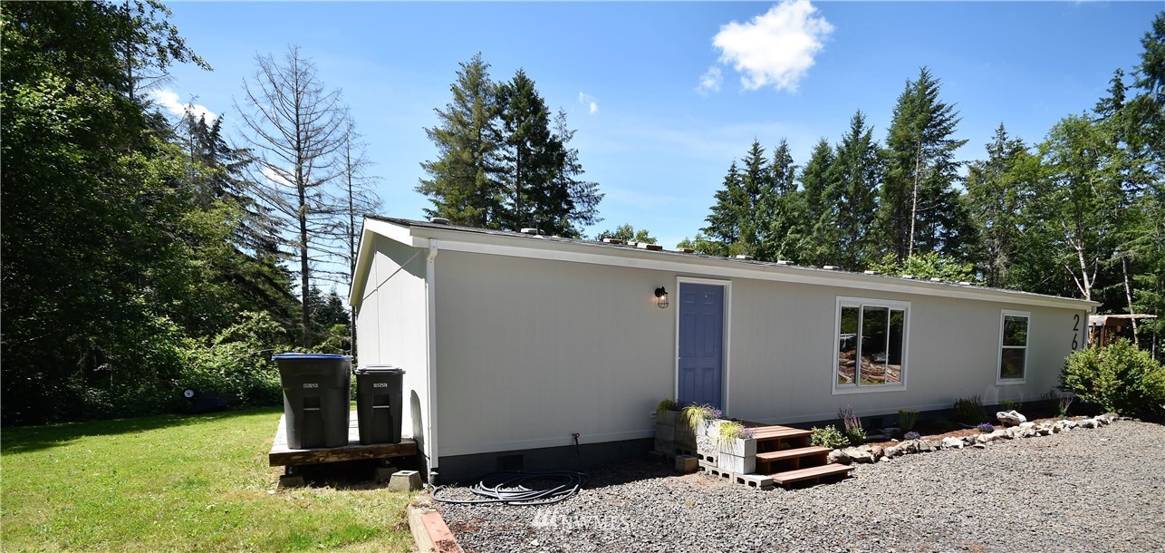267 East Victor Road Belfair, WA 98528 - Photo 5 of 27 a backyard of a house with table and chairs