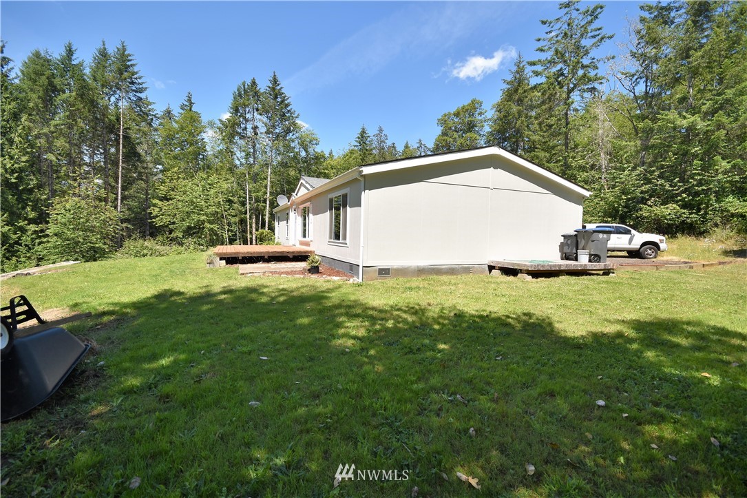 267 East Victor Road Belfair, WA 98528 - Photo 6 of 27 a view of a house with a yard and sitting area