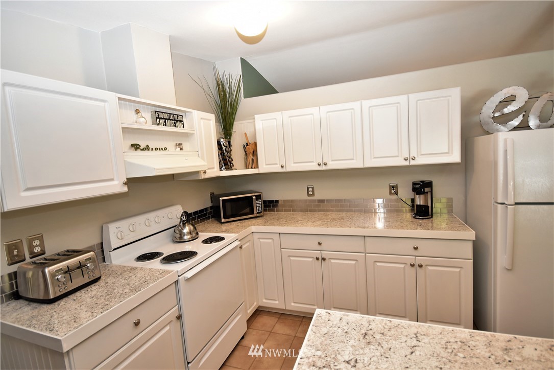267 East Victor Road Belfair, WA 98528 - Photo 8 of 27 a kitchen with a white cabinets and white appliances