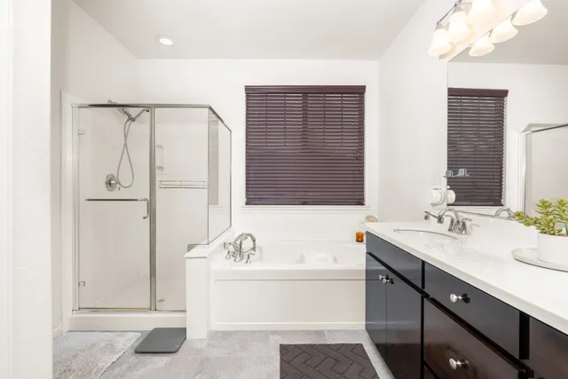 a bathroom with a tub sink and mirror
