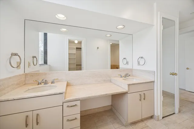 a bathroom with a sink vanity and mirror