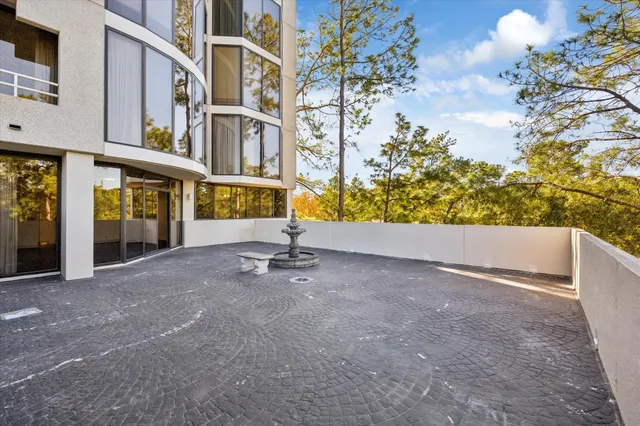 a view of terrace with wooden fence and trees