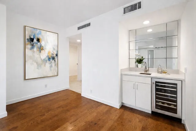 a bathroom with a sink a vanity and a painting