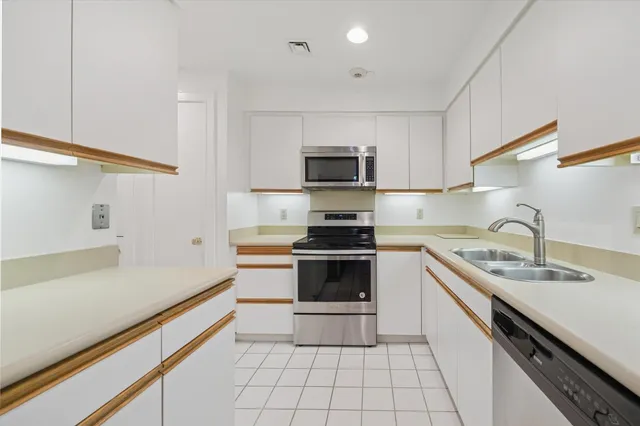 a kitchen with a sink stove and microwave