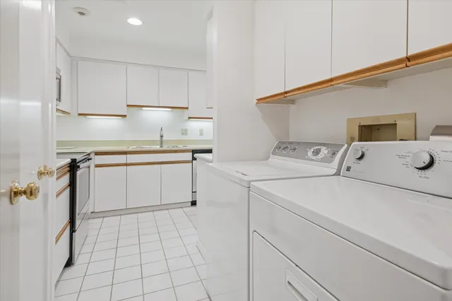 a bathroom with a granite countertop sink mirror and a painting on the wall