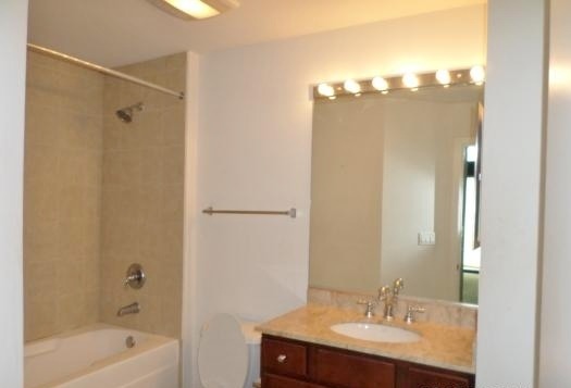 1151 West 15th Street, Unit 104 Chicago, IL 60608 - Photo 5 of 9 a bathroom with a sink double vanity and a mirror