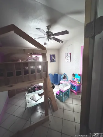 a room with furniture and a chandelier fan