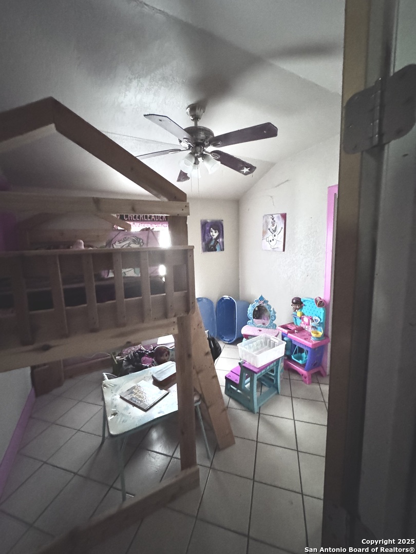 18186 Wisdom Road Lytle, TX 78052 - Photo 4 of 15 a room with furniture and a chandelier fan