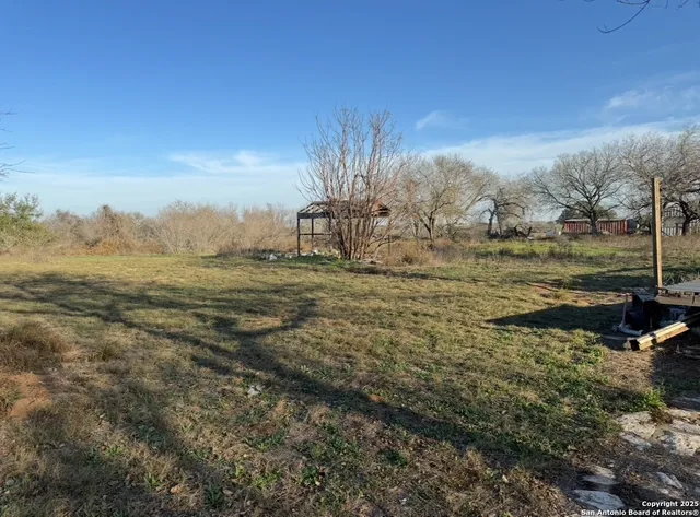 a view of a field with an ocean