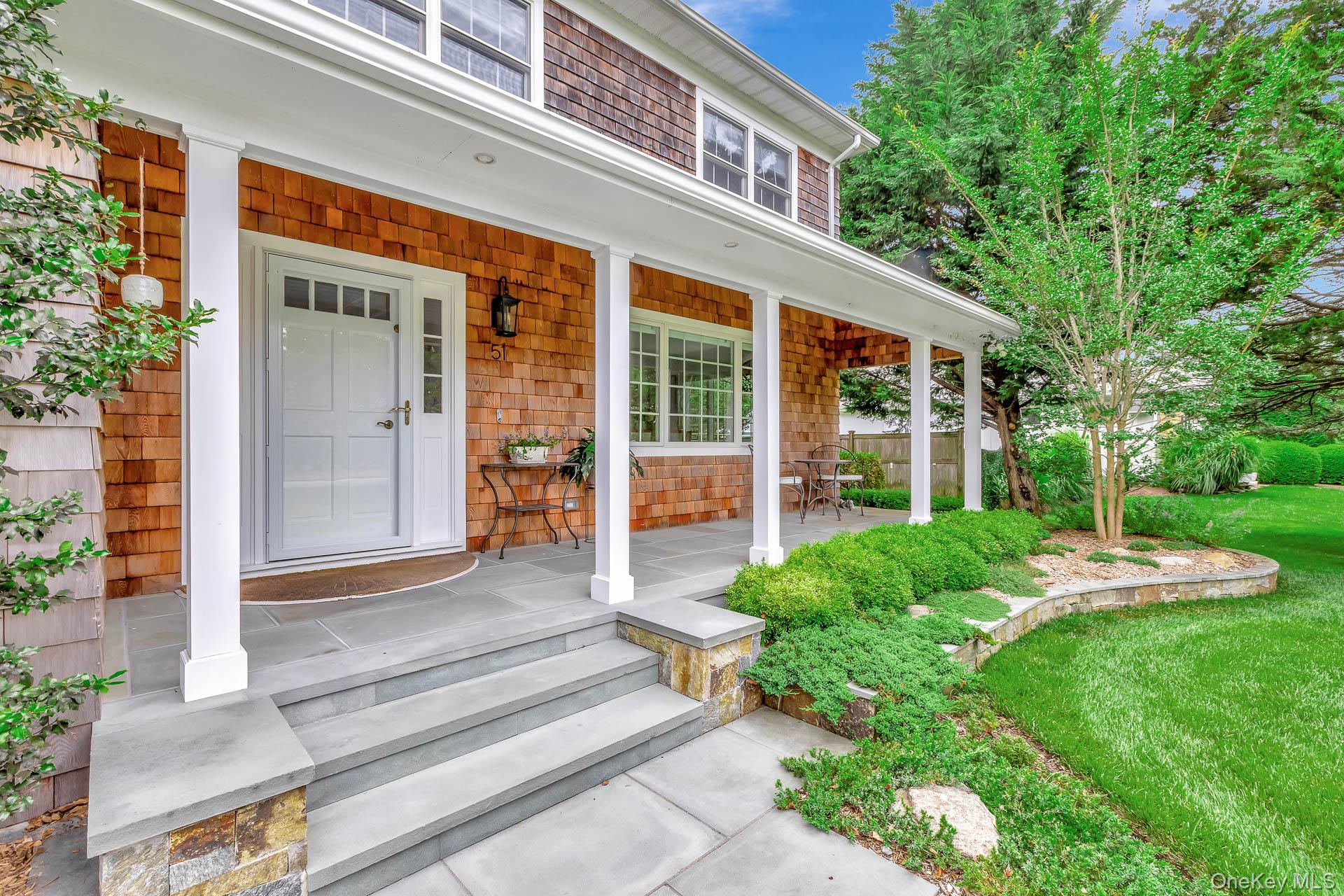 a front view of a house with a yard table and chairs