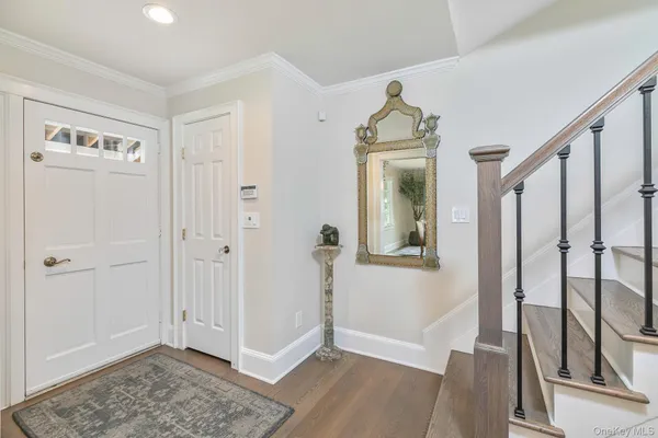 a view of a hallway view with wooden floor and staircase