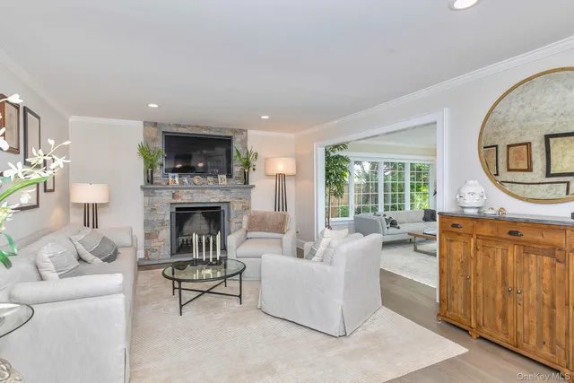 a living room with furniture a fireplace and a large window
