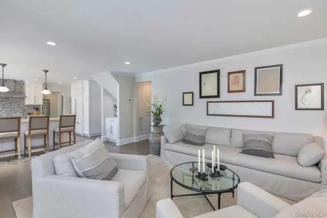 a living room with furniture kitchen and a table