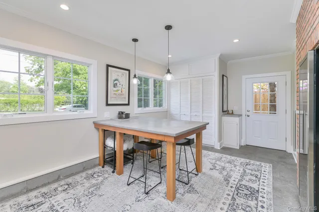 a view of a kitchen with a table and chairs