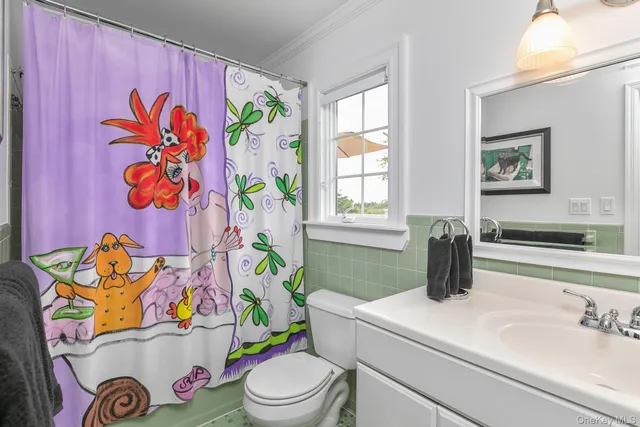 a bathroom with a sink mirror vanity and toilet