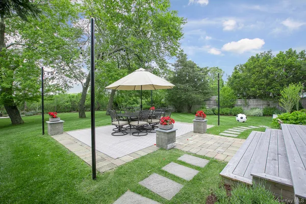 a view of a backyard with plants and patio