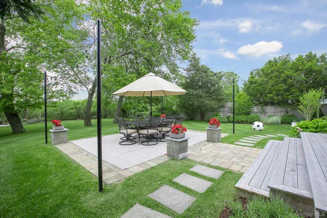 a view of a backyard with plants and patio