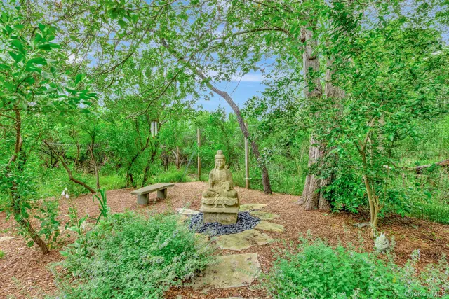 a backyard of a house with yard table and chairs