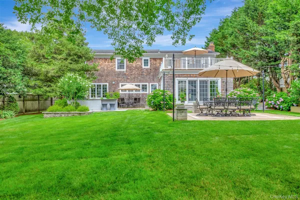 a front view of a house with a yard table and chairs