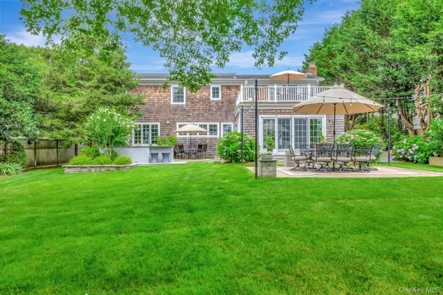 a front view of a house with a yard table and chairs