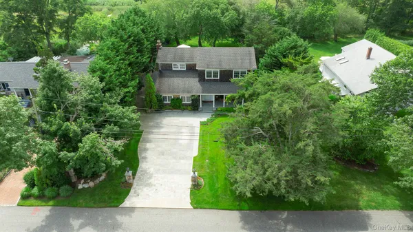 an aerial view of a house with garden space and a street view