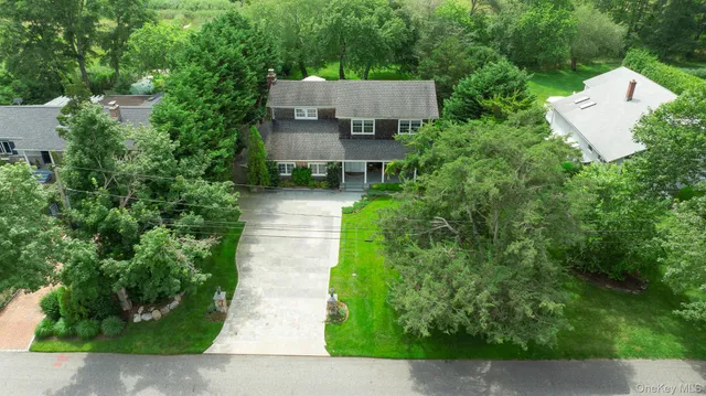 an aerial view of a house with garden space and a street view