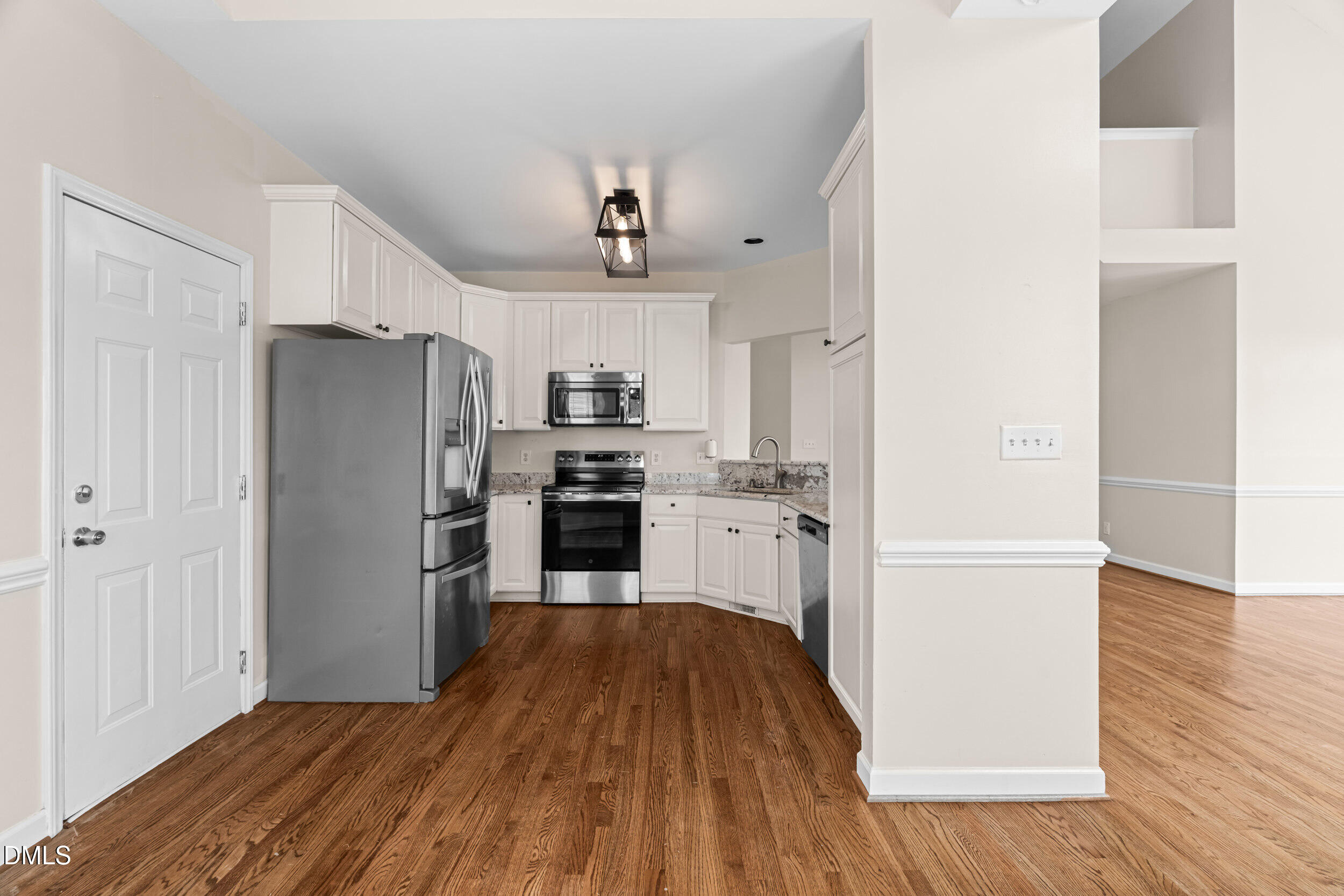 744 Seastone Street Raleigh, NC 27603 - Photo 22 of 53 a kitchen with wooden floors and refrigerator