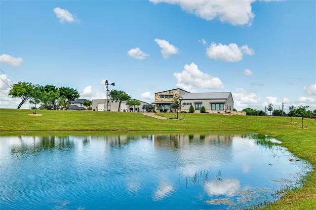 a view of a lake with houses in the background