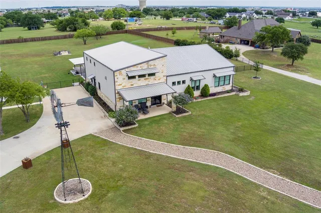 an aerial view of a house with a yard