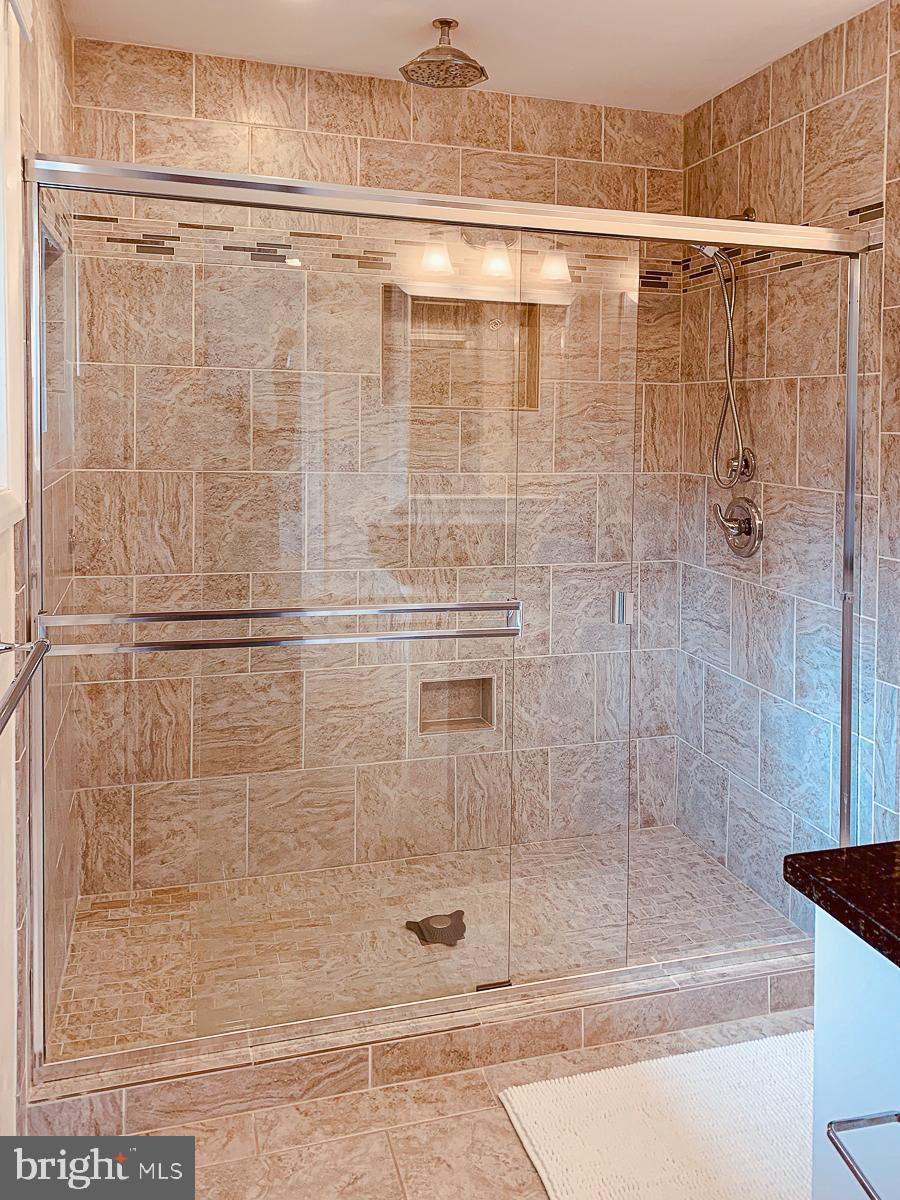 3301 Garrison Farms Road Pikesville, MD 21208 - Photo 15 of 41 Sleek glass shower in elegant tile setting.