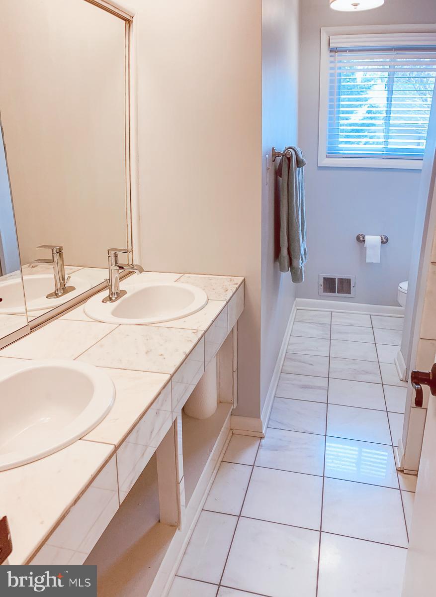 3301 Garrison Farms Road Pikesville, MD 21208 - Photo 24 of 41 Bright and airy bathroom with dual sinks.