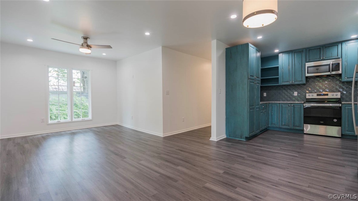 3616 Courthouse Road Hopewell, VA 23860 - Photo 15 of 40 an empty room with wooden floor a ceiling fan and kitchen view