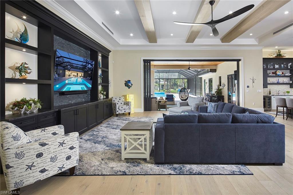 5301 Tamarind Ridge Drive Naples, FL 34119 - Photo 13 of 50 a living room with furniture and a flat screen tv