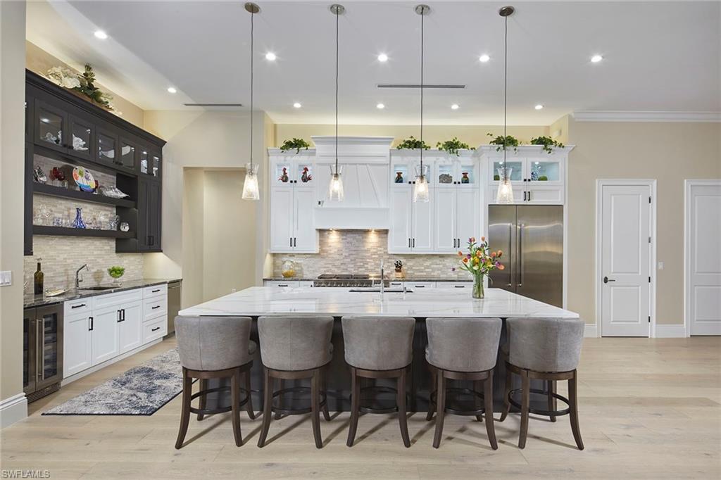 5301 Tamarind Ridge Drive Naples, FL 34119 - Photo 16 of 50 a large kitchen with a table and chairs