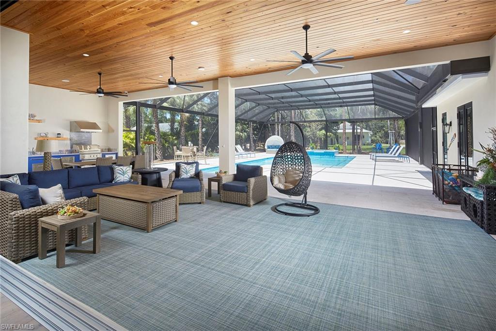 5301 Tamarind Ridge Drive Naples, FL 34119 - Photo 20 of 50 a building outdoor space with patio furniture and potted plants