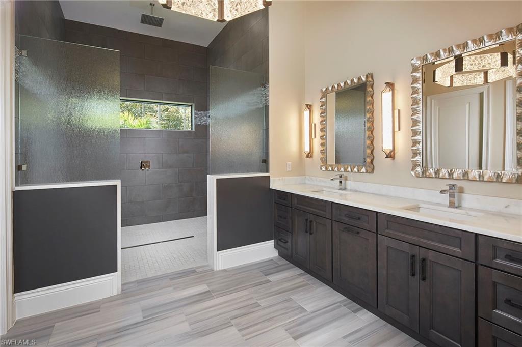 5301 Tamarind Ridge Drive Naples, FL 34119 - Photo 26 of 50 a bathroom with a double vanity sink and mirror