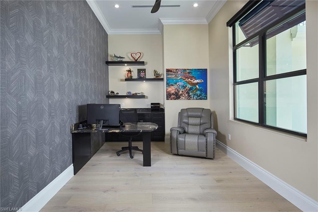 5301 Tamarind Ridge Drive Naples, FL 34119 - Photo 30 of 50 a workspace with furniture wall paintings and a window