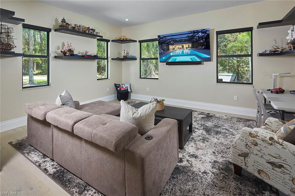 5301 Tamarind Ridge Drive Naples, FL 34119 - Photo 31 of 50 a living room with furniture and window