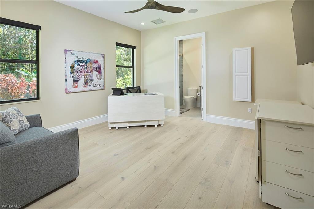 5301 Tamarind Ridge Drive Naples, FL 34119 - Photo 34 of 50 a living room with furniture and a window