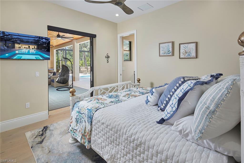 5301 Tamarind Ridge Drive Naples, FL 34119 - Photo 37 of 50 a bedroom with a bed and a painting on the wall