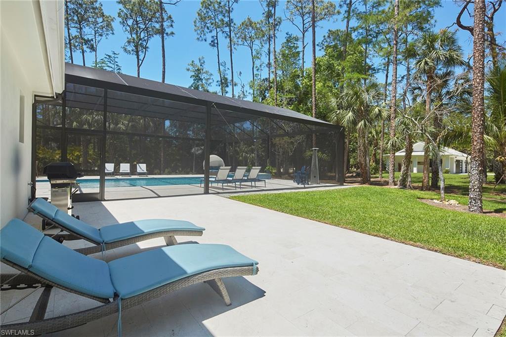5301 Tamarind Ridge Drive Naples, FL 34119 - Photo 43 of 50 a view of a patio with a table and chairs
