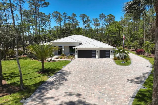 a backyard of a house with lots of green space and trees