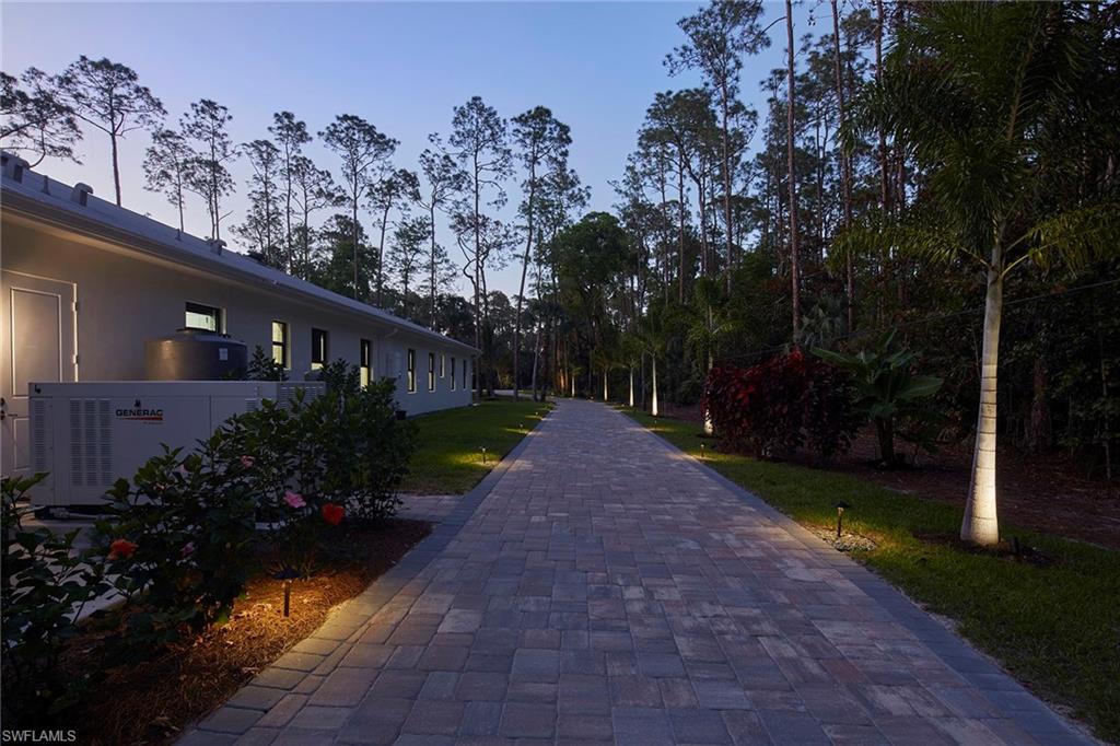 5301 Tamarind Ridge Drive Naples, FL 34119 - Photo 7 of 50 a view of a house with a yard and garden