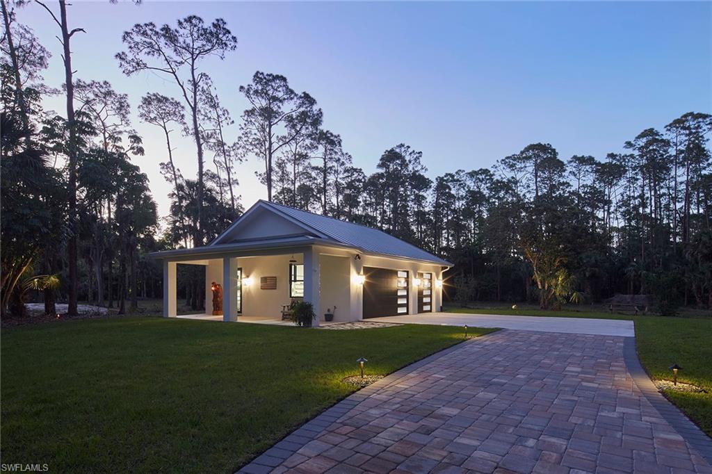 5301 Tamarind Ridge Drive Naples, FL 34119 - Photo 8 of 50 a front view of a house with a yard