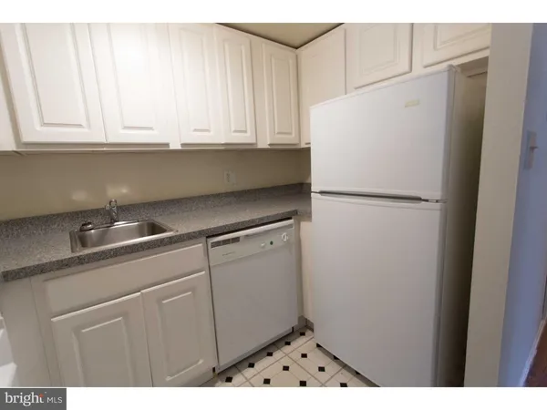 a kitchen with stainless steel appliances granite countertop a refrigerator sink and cabinets