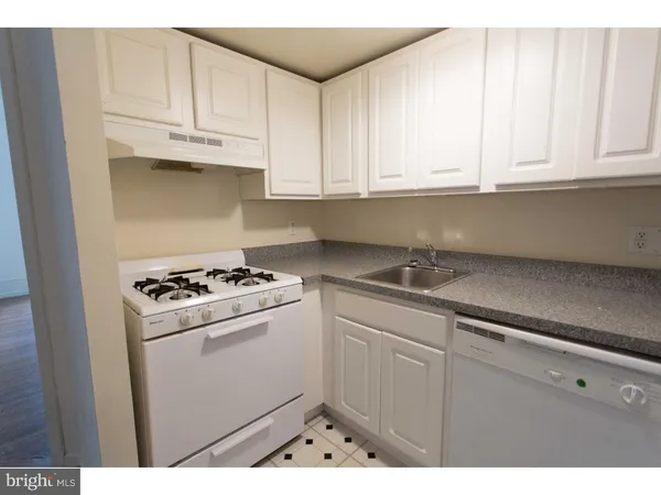 a kitchen with cabinets and a refrigerator