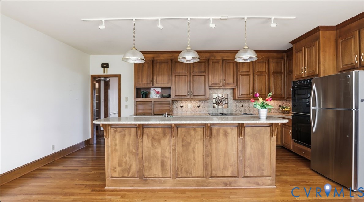 2560 Chartstone Drive Midlothian, VA 23113 - Photo 11 of 44 a kitchen with kitchen island a sink stainless steel appliances and cabinets