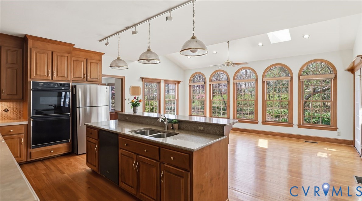 2560 Chartstone Drive Midlothian, VA 23113 - Photo 12 of 44 a kitchen with stainless steel appliances granite countertop a refrigerator a stove and a sink with large window