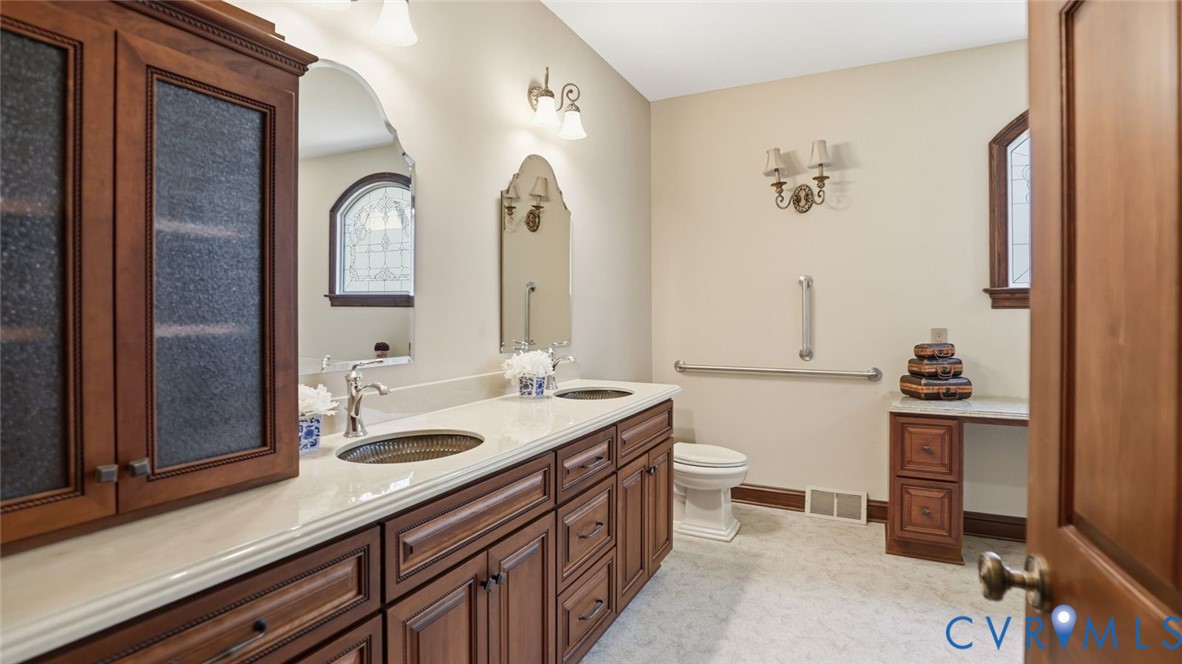 2560 Chartstone Drive Midlothian, VA 23113 - Photo 21 of 44 a spacious bathroom with a double vanity sink a mirror and a toilet